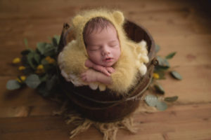 new born photography workshop with new born baby sleeping in a basked pictured by Nicoleta Raftu