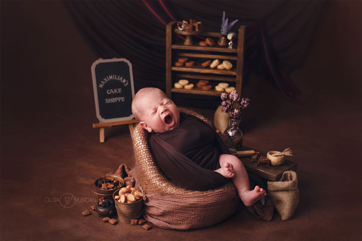 Olga Vuscan New Born Photographer for Workshops by Camen Bergmann Studio new born baby yawns in a library-like background
