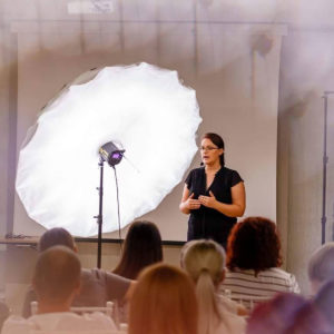 Olga Vuscan New Born Photographer for Workshops by Camen Bergmann Studio presenting in front of audience